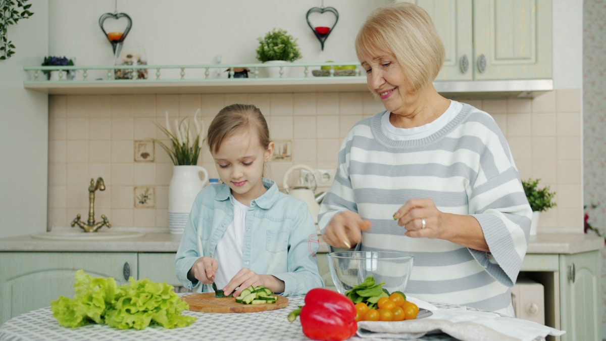 Older adult preparing vegetables in a home kitchen