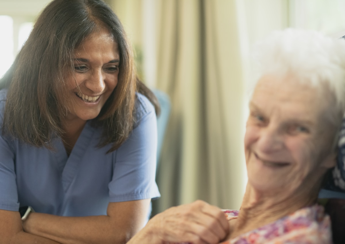 Caregiver providing respectful personal care support in a home setting