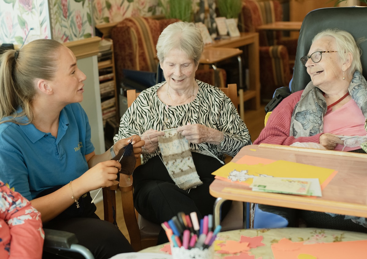 Caregiver supporting older adults with a social activity